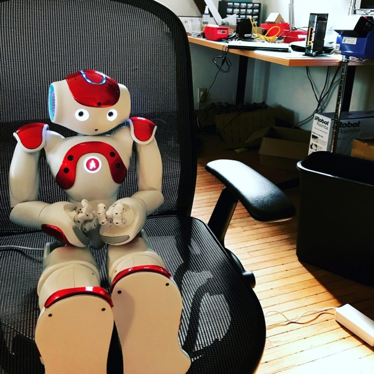 Nao the robot sitting in a chair