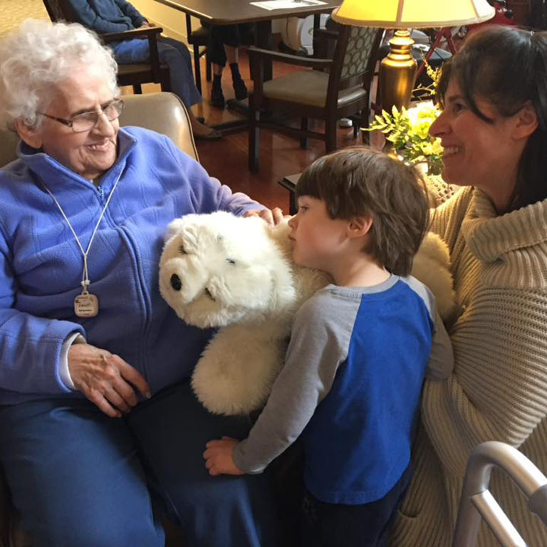 Elderly woman and a boy interacting with Paru the robot