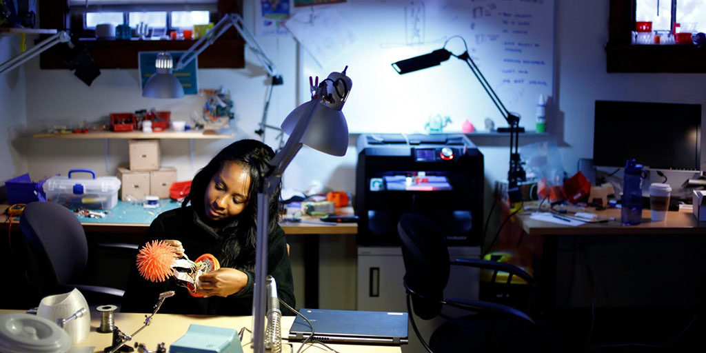 Natasha Randall working on a robot in the lab