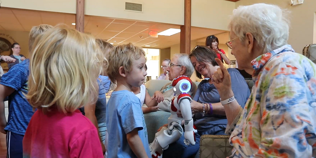 Children and elderly women interacting with Nao the robot